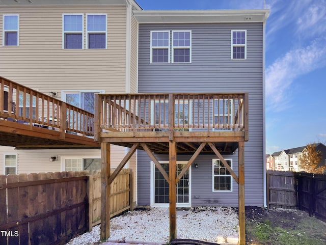 rear view of house featuring a wooden deck