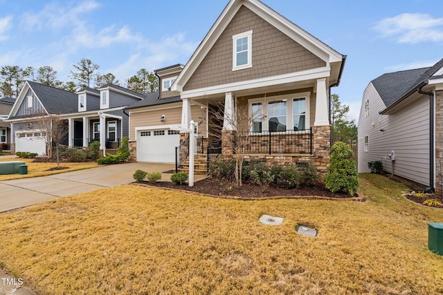 craftsman house with covered porch and a front yard