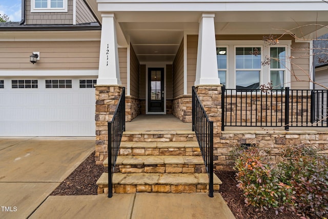 doorway to property featuring covered porch and a garage