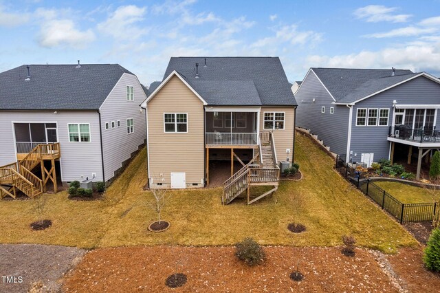 back of house featuring a lawn, central AC, and a sunroom