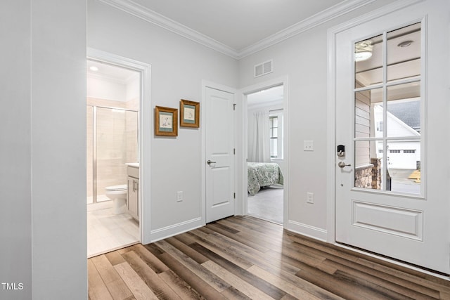 foyer with crown molding and light hardwood / wood-style floors