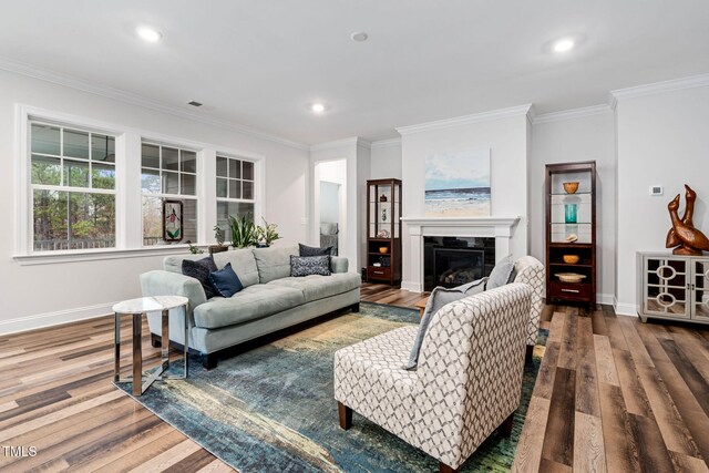 living room with hardwood / wood-style flooring and ornamental molding