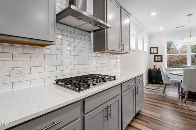 kitchen featuring pendant lighting, gray cabinets, wall chimney range hood, and dark wood-type flooring