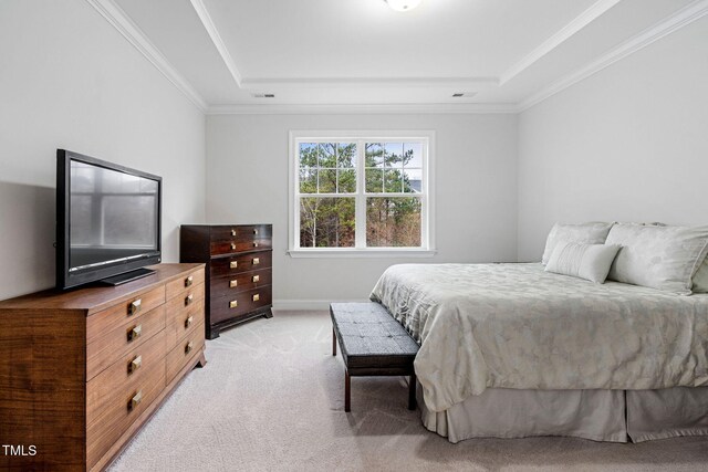 carpeted bedroom with a raised ceiling and ornamental molding