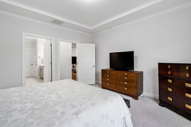 bedroom with connected bathroom, light colored carpet, and ornamental molding