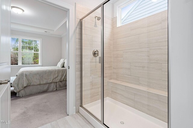 bathroom featuring an enclosed shower and crown molding