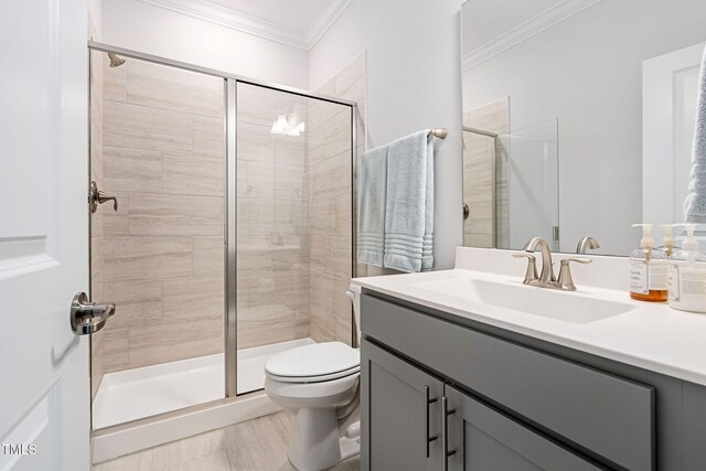 bathroom with vanity, toilet, walk in shower, and ornamental molding