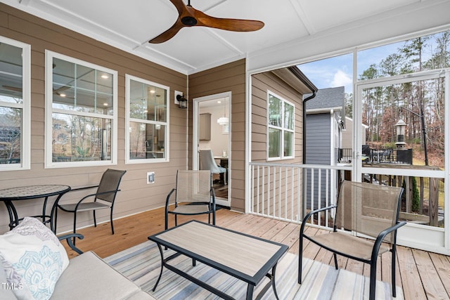 sunroom with a wealth of natural light and ceiling fan