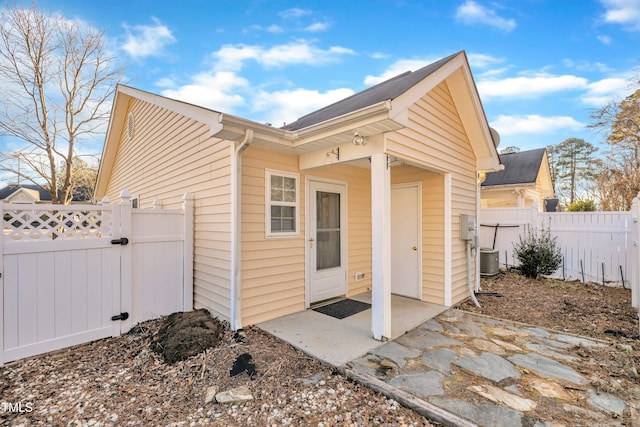 rear view of property featuring a patio area and central air condition unit