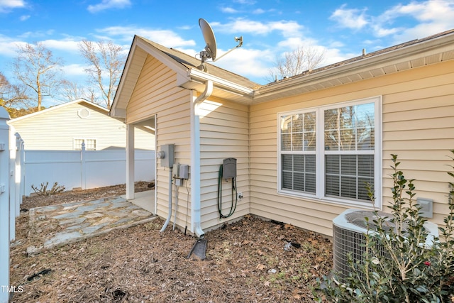 view of side of property featuring a patio area and cooling unit