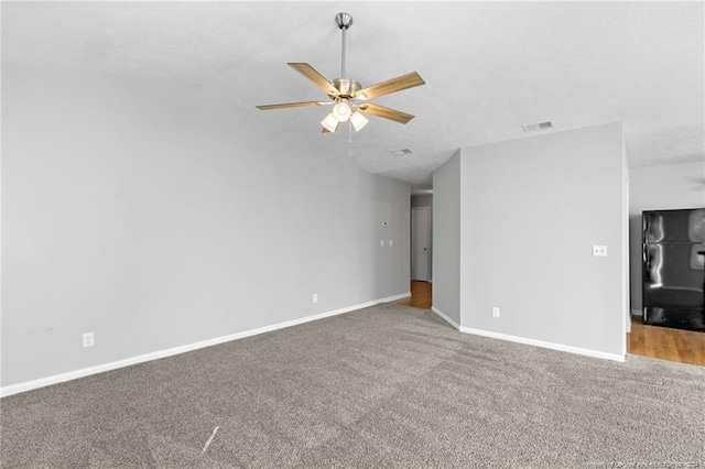 unfurnished living room featuring ceiling fan, carpet, and vaulted ceiling