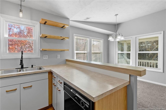 kitchen with pendant lighting, a healthy amount of sunlight, carpet floors, and sink