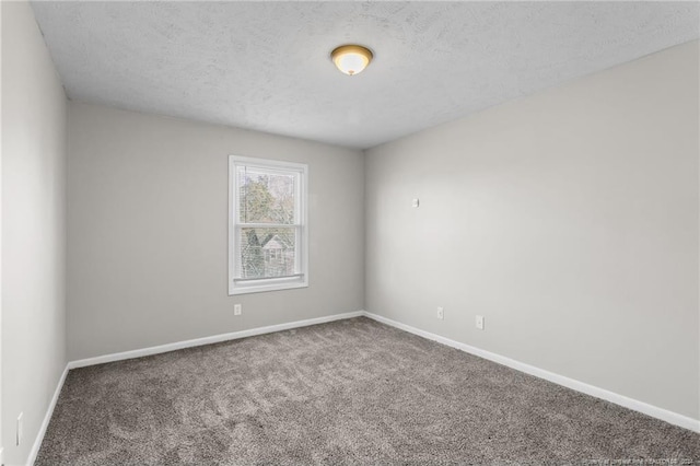 unfurnished room with carpet floors and a textured ceiling