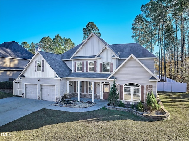 view of front of property with a garage, a porch, and a front yard