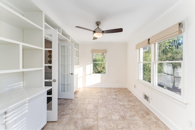 spare room with ceiling fan, crown molding, and french doors