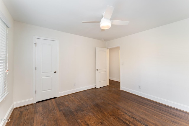 unfurnished room with ceiling fan and dark wood-type flooring