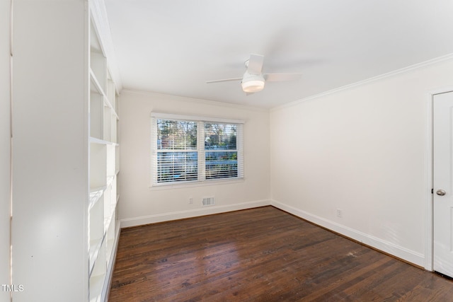 spare room featuring ceiling fan, dark wood-type flooring, and ornamental molding