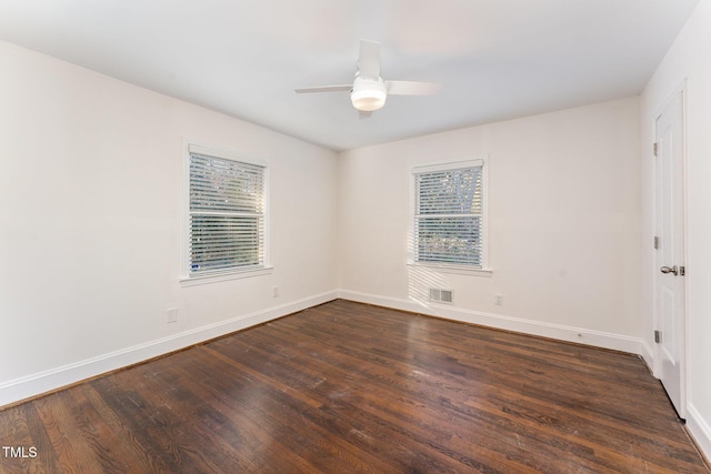 empty room featuring dark hardwood / wood-style flooring and ceiling fan