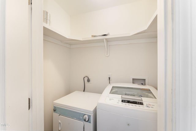 clothes washing area featuring washer and clothes dryer