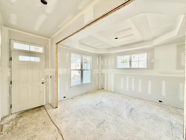 foyer featuring a raised ceiling