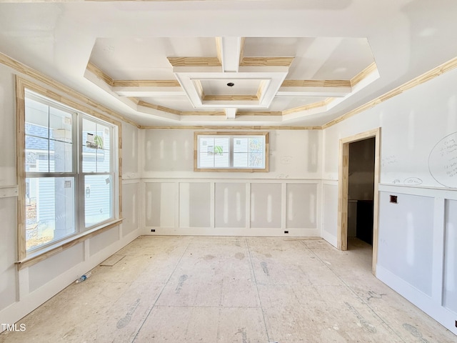 spare room with crown molding, coffered ceiling, and a decorative wall