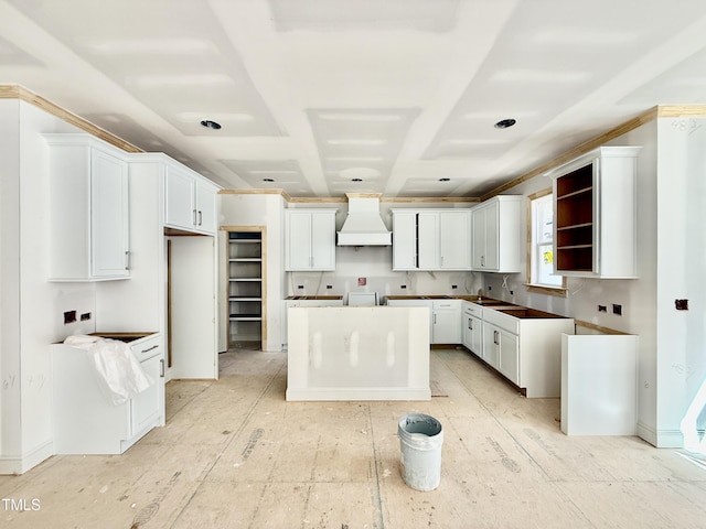 kitchen with premium range hood, white cabinetry, open shelves, and a center island