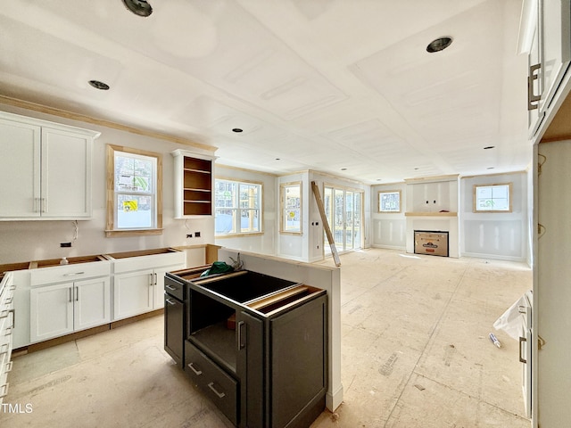 kitchen featuring white cabinetry, open floor plan, and a center island