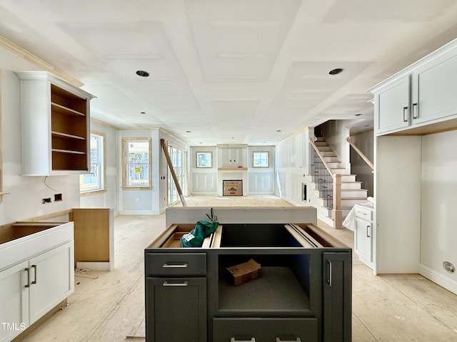 kitchen with a healthy amount of sunlight, white cabinetry, and open shelves