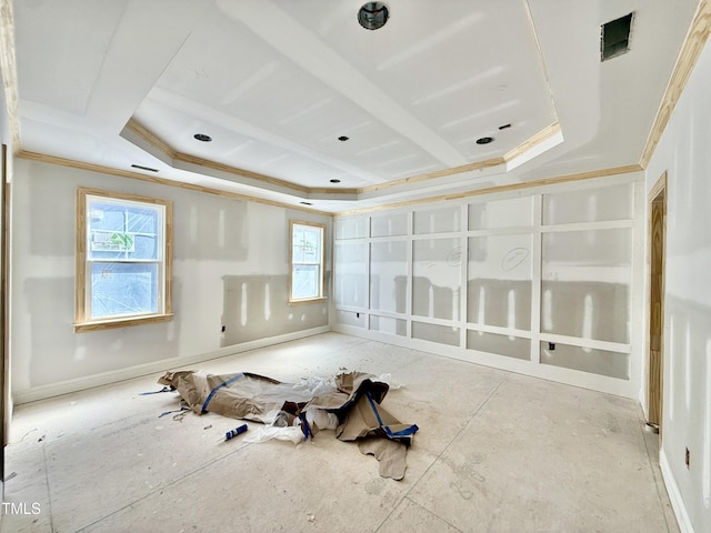 empty room with a healthy amount of sunlight, a tray ceiling, and ornamental molding