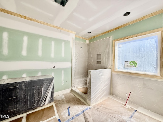 bathroom featuring a marble finish shower