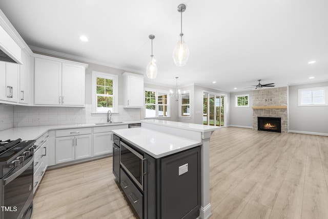 2625 Silver Gate Ct, Wake Forest, NC 27587 - kitchen featuring stainless steel microwave, gas range, white cabinetry, light countertops, and recessed lighting