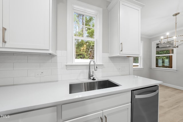 2625 Silver Gate Ct, Wake Forest, NC 27587 - kitchen with light countertops, white cabinetry, tasteful backsplash, a chandelier, and crown molding