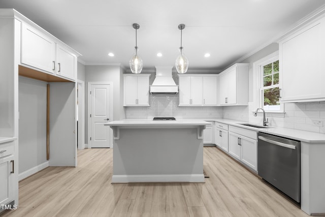 2625 Silver Gate Ct, Wake Forest, NC 27587 - kitchen with stainless steel dishwasher, custom exhaust hood, light wood-style flooring, decorative backsplash, and crown molding