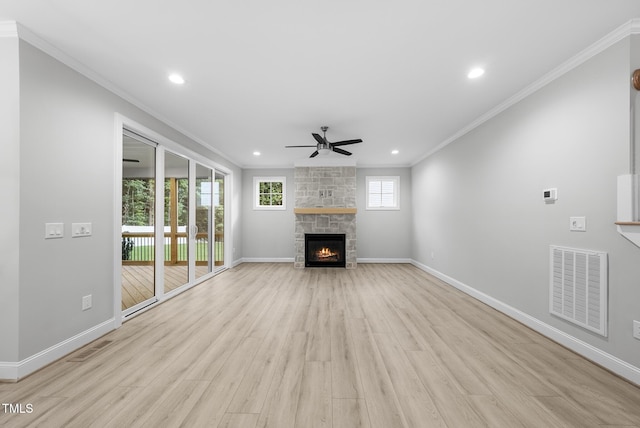 2625 Silver Gate Ct, Wake Forest, NC 27587 - unfurnished living room featuring crown molding, ceiling fan, light wood finished floors, recessed lighting, and a stone fireplace