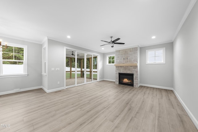 2625 Silver Gate Ct, Wake Forest, NC 27587 - unfurnished living room featuring ornamental molding, ceiling fan, a fireplace, light wood-type flooring, and healthy amount of natural light