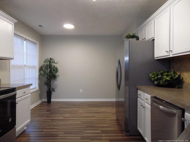 kitchen featuring stainless steel appliances, dark hardwood / wood-style floors, and white cabinets