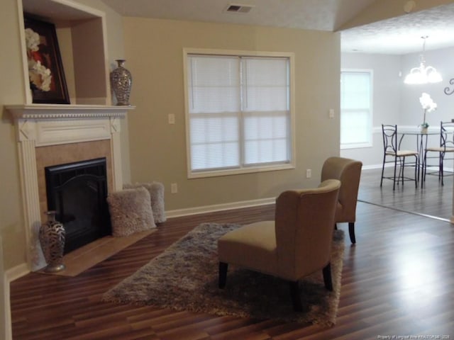 sitting room with dark hardwood / wood-style floors and a chandelier