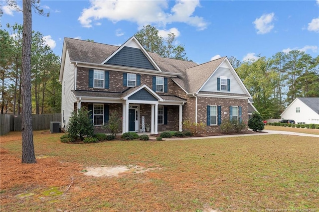 craftsman-style house with central AC unit, covered porch, and a front lawn