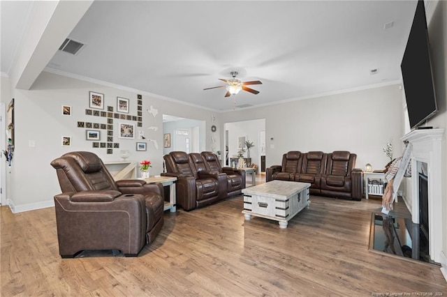 living room featuring ceiling fan, hardwood / wood-style floors, and ornamental molding