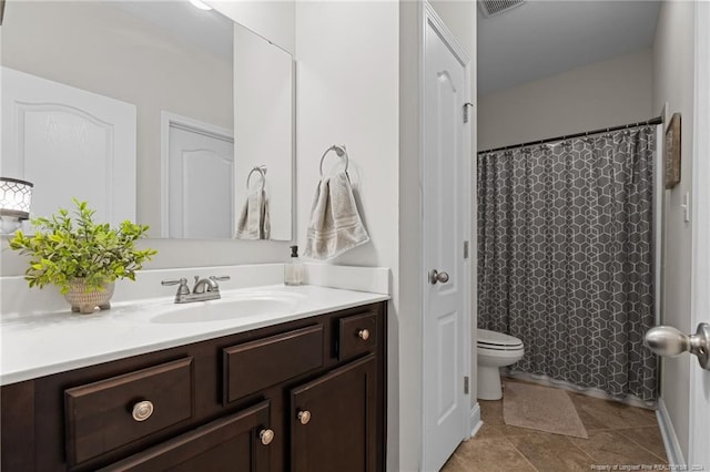 bathroom featuring tile patterned floors, vanity, and toilet