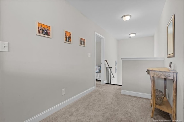 hallway with light colored carpet