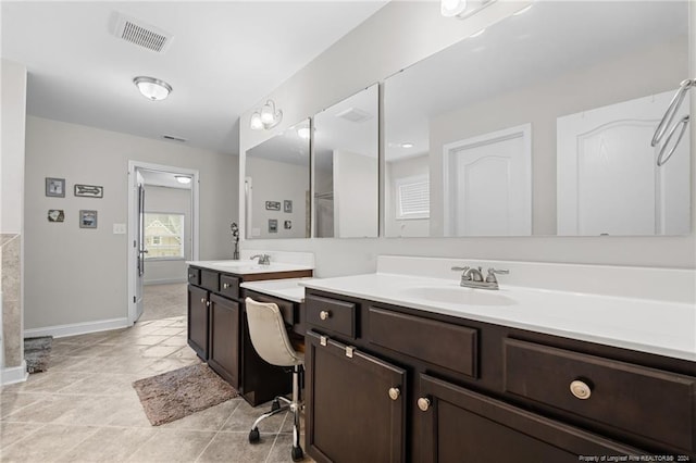 bathroom with tile patterned floors and vanity