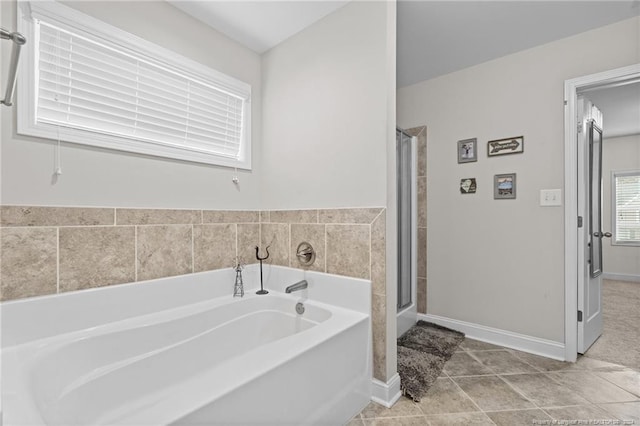 bathroom featuring tile patterned flooring and shower with separate bathtub