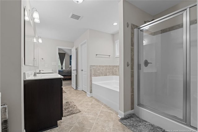 bathroom with tile patterned flooring, vanity, and independent shower and bath