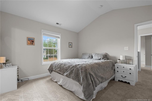 carpeted bedroom featuring lofted ceiling