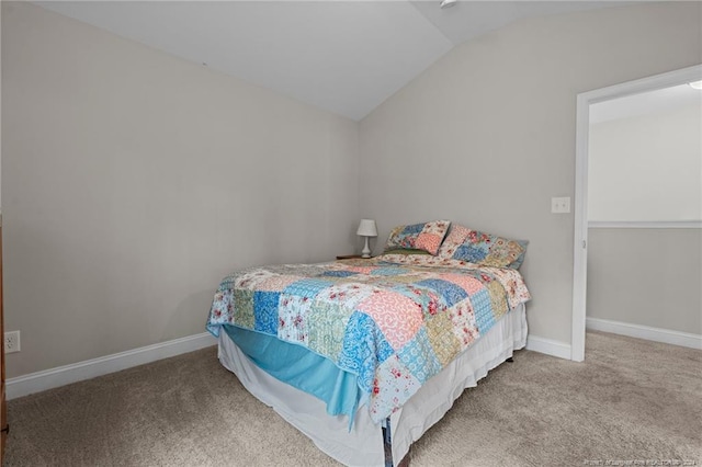 bedroom featuring carpet floors and vaulted ceiling