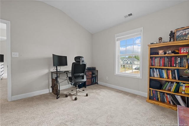 office space featuring carpet floors and vaulted ceiling