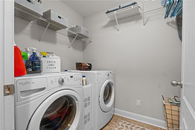 laundry room with washer and dryer and light tile patterned floors