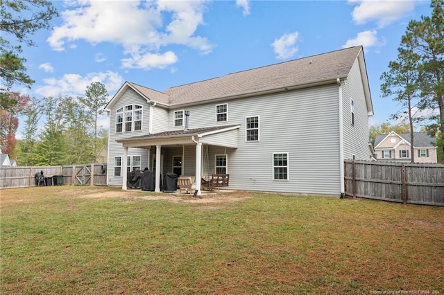 rear view of property with a lawn