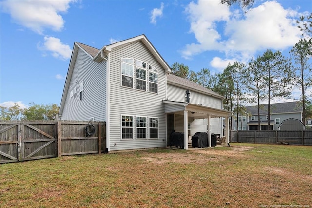 back of house featuring a yard